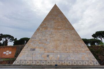Fototapeta na wymiar Italy Rome Pyramid of Cestius on a cloudy spring day