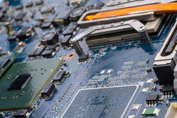 Concept laptop technology. A detailed shot of a computer motherboard, featuring a CPU, chipsets and...