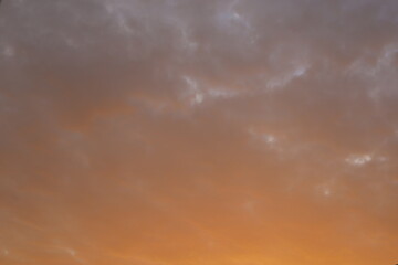 pinkish sunset sky with few clouds 