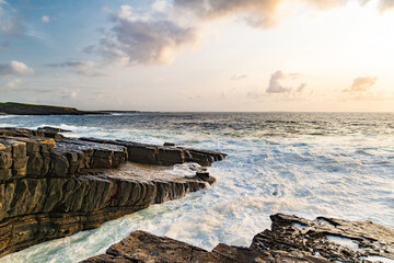 Sunset view of Mullaghmore Head with huge waves rolling ashore. Picturesque scenery with rocky...