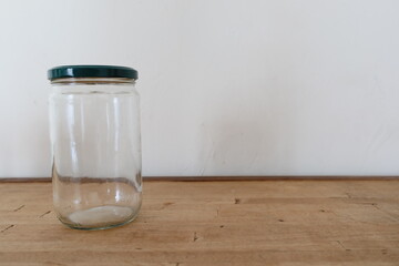 transparent empty glass jar on wooden counter