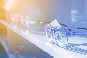 exhibitor of glasses consisting of shelves of fashionable glasses shown on a wall at the optical shop - obrazy, fototapety, plakaty