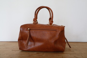 brown leather handbag presentation on minimalist background