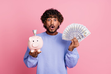 Photo of crazy cheerful guy open mouth wear trendy clothes showing piggy bank saving salary storage...