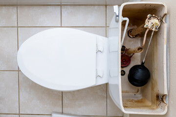 Residential home bathroom toilet tank plumbing repair. Replacing old leaking restroom lavatory...