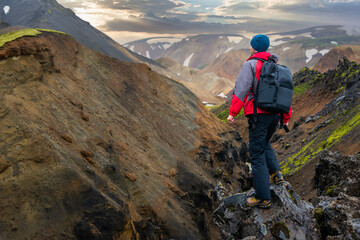 Hiker traveling in Landmannalaugar mountains in Iceland