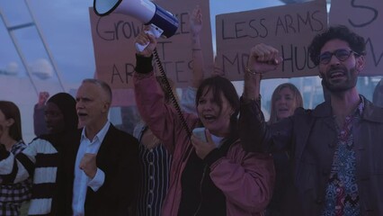 Diverse group of activists people holding posters and banners antiwar protesting against war and violence in the world.