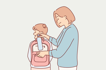 Mom puts bottle of water in daughter school backpack, taking care of child leaving for walk or study