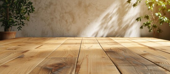 An empty wood board background with a natural pattern texture rests on a floor near a wooden table, featuring a potted plant in the background.