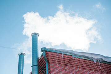 Metal chimney of a geothermal power station with stainless steel pipe structure with smoke and steam