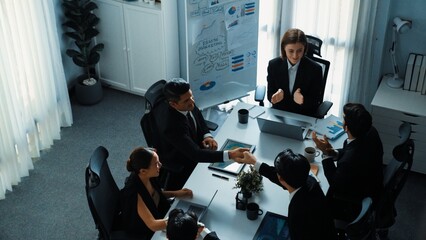 Top view of smart executive manager looking at financial graph while skilled business team shake...