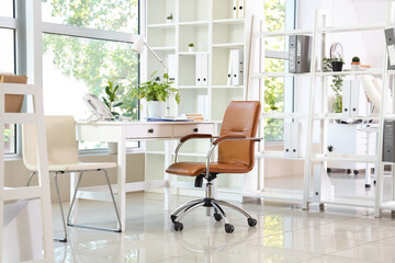 Interior of modern medical office with doctor's workplace and window