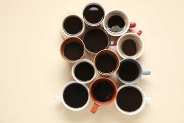 Many cups of hot coffee on beige background