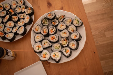 Fresh Homemade Sushi Roll against old wooden table.