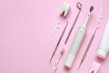 Dental tools and oral hygiene supplies on pink background. World Dentist Day