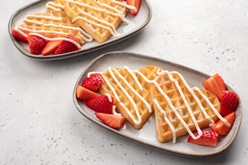 Belgian waffles in shape of heart with strawberries
