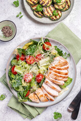 Grilled chicken breast and fresh vegetable salad of lettuce and tomato