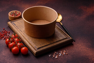 Empty ceramic round plate on dark textured concrete background