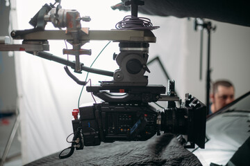 Professional cinema and video camera on the set. Shooting shift, lighting fixtures, shooting equipment and the team.
