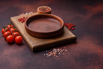 Empty ceramic round plate on dark textured concrete background