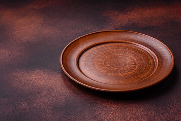 Empty ceramic round plate on dark textured concrete background