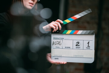 Assistant director with clapperboard on set. Close-up of firecrackers for filming a movie