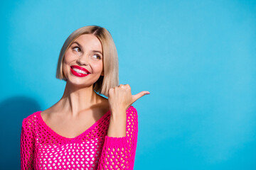 Photo of adorable cute girl wear pink trendy clothes thumb demonstrate empty space news logo isolated on blue color background