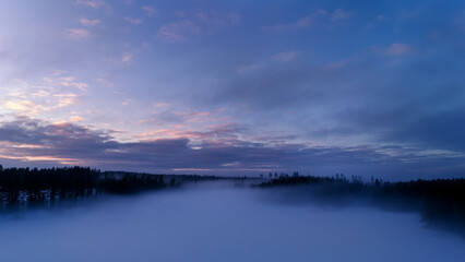 Wonderful foggy aerial view of winter landscape