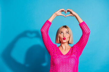 Photo of adorable cute lady coquette wear trendy clothes showing heart figure love you empty space isolated on blue color background
