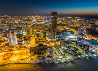 Fototapeta premium Yekaterinburg city with Buildings of Regional Government and Parliament, Dramatic Theatre, Iset Tower, Yeltsin Center, panoramic view at winter sunset.