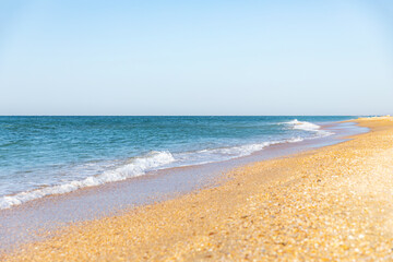 Soft blue sea and ocean wave on clean sandy beach. Summer vacation concept.