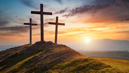 Three crosses on hill at sunset, symbolizing Crucifixion of Jesus Christ. Religious concept with space for caption