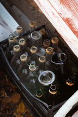 Vintage glass bottles in a crate, with twine necks, reflecting eco-friendly recycling concepts, ideal for touristic and lifestyle publications