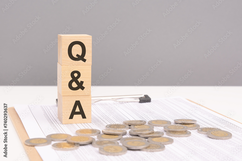 Poster wooden cubes on a brown background with the text q and a - an abbreviation for question and answer. 
