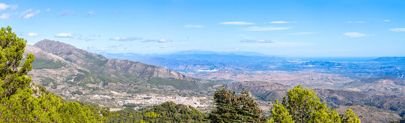 Fototapeta na wymiar Panoramic view on pine forest on hiking trail to peak Torrecilla, Sierra de las Nieves national park, Andalusia, Spain