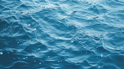 Fototapeta premium Tranquil Blue Water Surface with Delicate White Bubbles Floating Gently in Sunlight