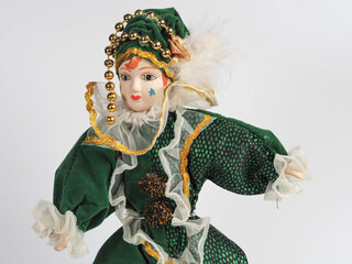 Porcelain Italian doll depicting the hero of the Commedia Del Arte in a green suit. - 740301875