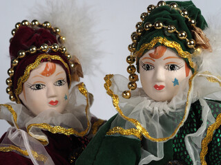 Two Porcelain Italian dolls depicting the hero of the Commedia Del Arte in red and green costumes. - 740302426