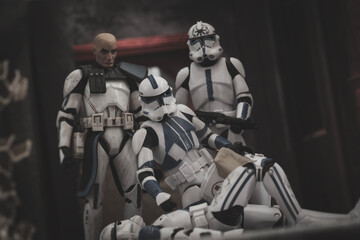 Obraz premium NEW YORK USA, FEB 25 2024: scene from the Clone Wars, medic Kix tends to a wounded 501st trooper - bootleg action figures