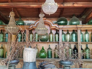 Bottles on Shelves with Chandeliers - Italy 