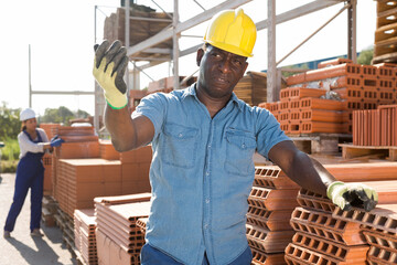 Portrait of a concentrated african american man worker standing in a building materials store in an...