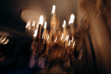 Photo in motion with smear. Crystal chandeliers of the sunset. Wonderful wedding decor with...