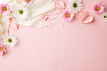 A canvas of spring: blooms and love's tokens. Top view shot of white and pink flowers, scattered paper hearts, cream scarf on soft pink background with space for advertising or heartfelt salutations