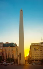 Papier Peint photo Buenos Aires Obelisk of Buenos Aires, Argentina at Sunset. Golden hues paint the sky behind Buenos Aires' iconic Obelisk, creating a breathtaking image. 