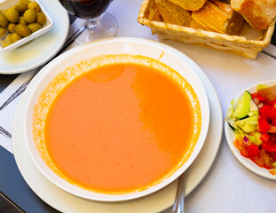 Tomato soup Gazpacho served with baguette - traditional Spanish dish