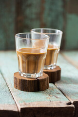 Vietnamese coffee in glass cups on old boards