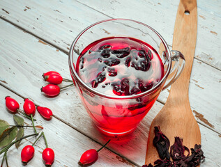 Therapeutic rosehip tea, red tea in a transparent cup, rosehip berry with herbal tinctures for...