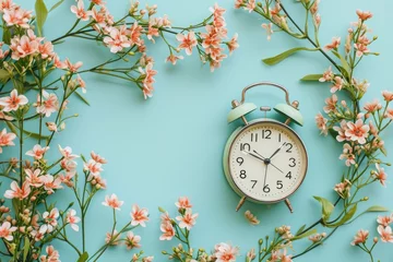 Foto op Canvas A vintage alarm clock surrounded by a vibrant array of spring flowers on a soothing pastel background, illustrating the concept of spring time © netrun78