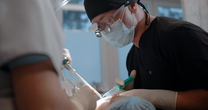 Patient is going through dental surgery in dental clinic
