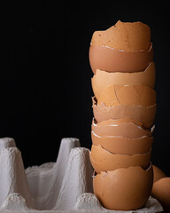 Egg shells stacking on black background, eggshell on a cardboard egg box